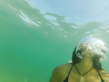 Close-up of woman swimming underwater