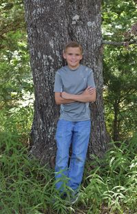 Portrait of smiling girl on tree trunk