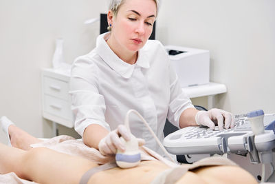 Gynecologist examining patient