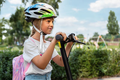 Close-up of girl riding push scooter