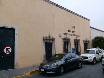 Cars parked on street against building