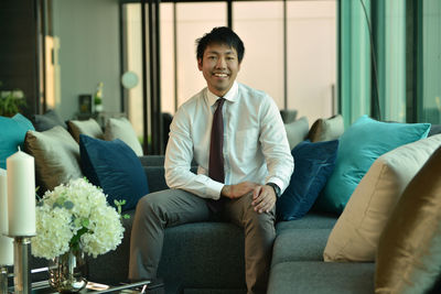 Businessman sitting on sofa in office