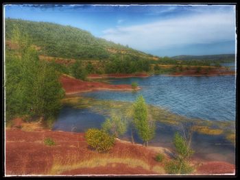 Scenic view of lake against blue sky