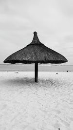 Built structure on beach against sky