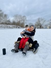 Mother and son playing in the snow