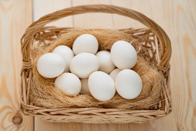 High angle view of eggs in basket on table