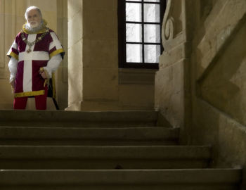 Man standing in corridor of building