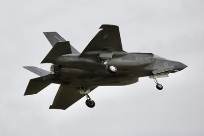 Low angle view of airplane flying against sky