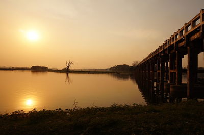 Scenic view of sunset with old woody bridge