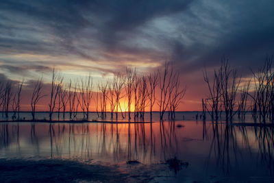 Scenic view of lake against sky at sunset