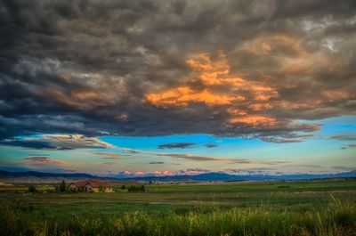 Scenic view of field against sky during sunset