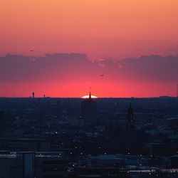 Silhouette buildings against sky during sunset