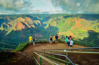 People on mountain against sky