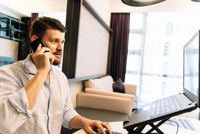 Man using mobile phone in office