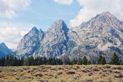 Scenic view of mountains against cloudy sky