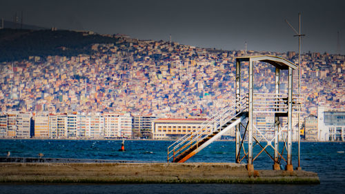 Scenic view of beach by buildings against clear sky