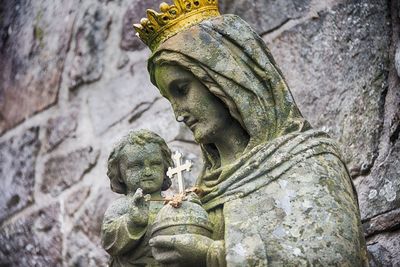 Low angle view of statues against wall