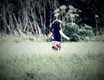 Woman jumping on grass