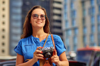 Portrait of young woman wearing sunglasses