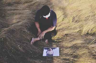 High angle view of man using mobile phone on field