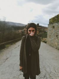 Portrait of smiling young woman standing in winter