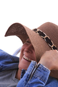 Low section of man wearing hat against white background