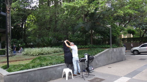 Street musician getting ready for performance on the sidewalk