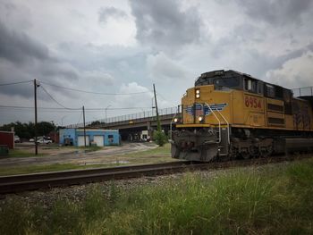 Train on railroad tracks against sky