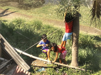 Children standing by tree