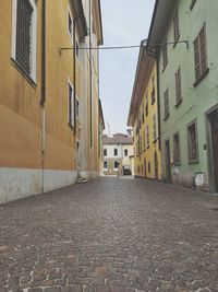 Empty alley amidst houses in town