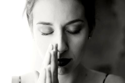 Close-up portrait of young woman with eyes closed