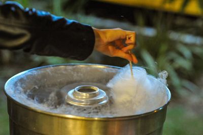 Cropped image of hand making cotton candy