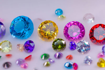 Close-up of colorful gemstones over white background
