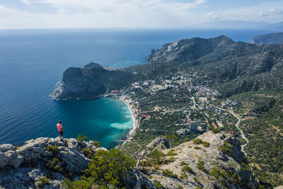 High angle view of sea and rocks against sky