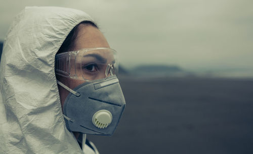 Close-up of woman wearing mask looking away