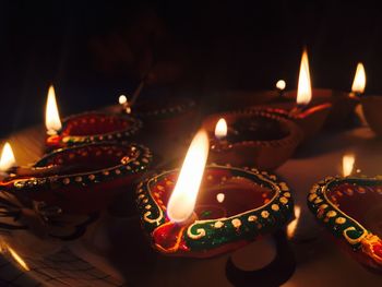 Close-up of lit diyas at home