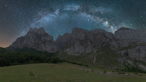 Scenic view of landscape against sky at night