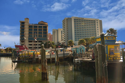 Boats moored in canal against buildings in city