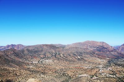 Scenic view of dramatic landscape against clear blue sky