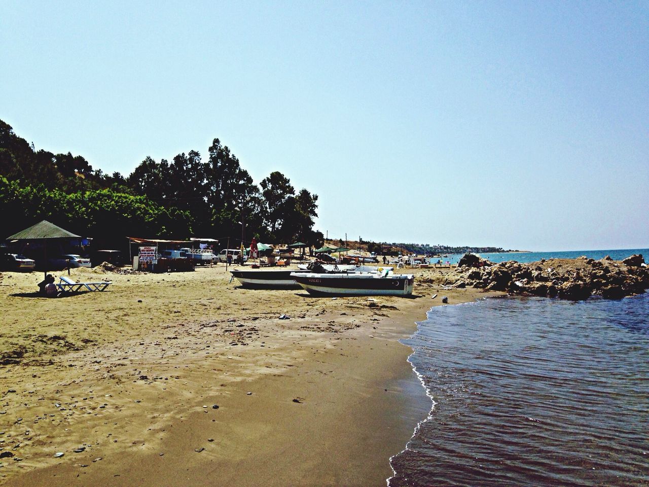 beach, clear sky, water, sand, sea, shore, copy space, nautical vessel, tranquility, boat, moored, transportation, tranquil scene, mode of transport, nature, scenics, incidental people, beauty in nature, tree, blue