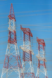 Low angle view of electricity pylon against sky