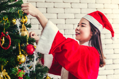 Midsection of girl with christmas tree