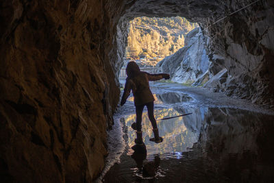 Full length of woman standing in cave