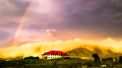 Scenic view of building against sky during sunset