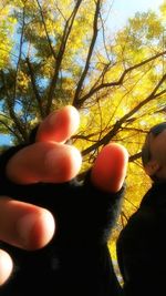 Close-up of woman hand against sky