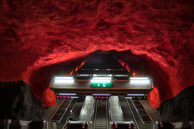 Low angle view of illuminated lighting equipment at night