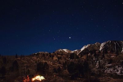 Scenic view of illuminated mountains against clear sky at night