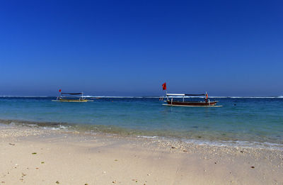 Scenic view of sea against clear blue sky