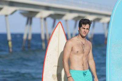 Young man standing at at beach