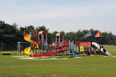 Playground in park against sky